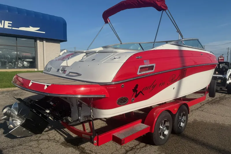 Slide: The Image of 2005 Crownline 270 BR boat with red and white design on a trailer. - 1