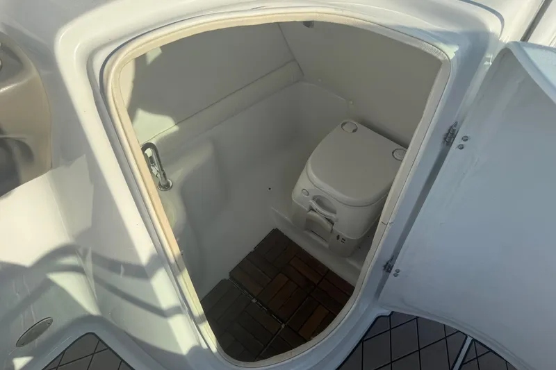 Slide: The Image of 2005 Crownline 270 BR boat interior with compact marine toilet. - 10