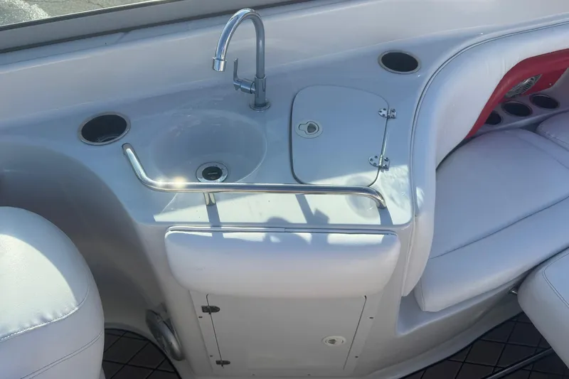 Slide: The Image of 2005 Crownline 270 BR boat interior with sink and seating area. - 16