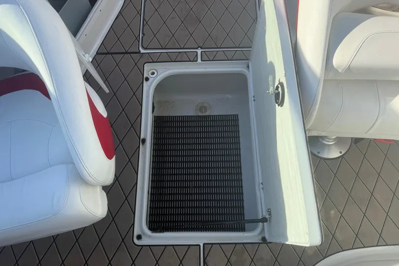 Slide: The Image of Open storage compartment on 2005 Crownline 270 BR boat deck with seating. - 17