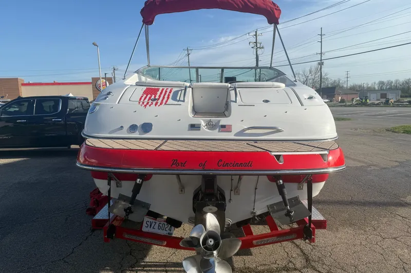 Slide: The Image of 2005 Crownline 270 BR boat with red accents, parked in Cincinnati. - 2