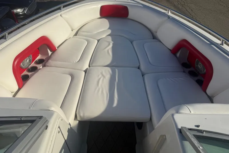 Slide: The Image of 2005 Crownline 270 BR boat interior with white cushioned seating and red accents. - 3
