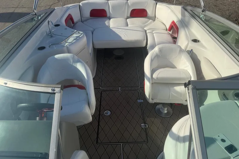 Slide: The Image of 2005 Crownline 270 BR boat interior with white seating and red accents. - 6
