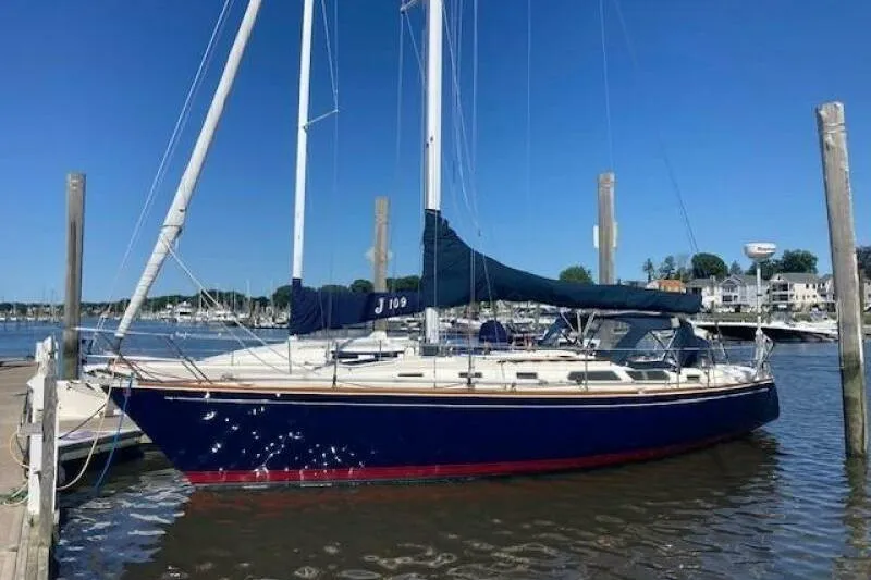 The Image of Sailboat docked at marina, 1990 Sabre 38 model, blue hull, clear sky background. - 0