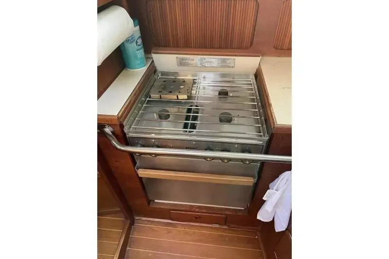 Slide: The Image of Stainless steel stove in 1990 Sabre 38 yacht kitchen, with wooden cabinetry. - 11
