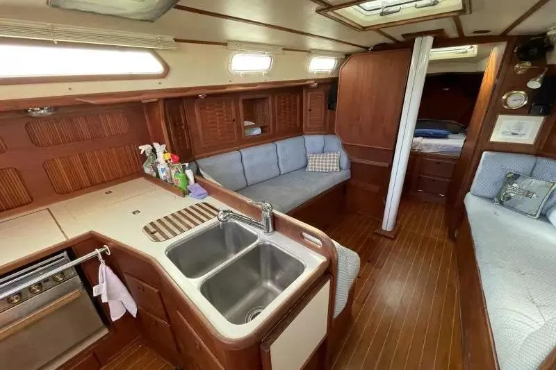 Slide: The Image of Interior of a 1990 Sabre 38 sailboat with wood finish and cozy seating area. - 12