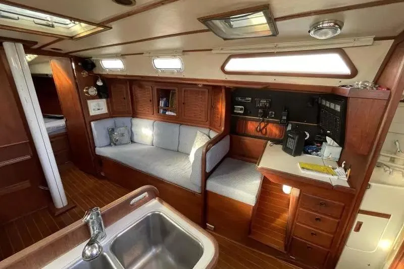 Slide: The Image of Interior of a 1990 Sabre 38 sailboat with wooden cabinetry and seating area. - 13