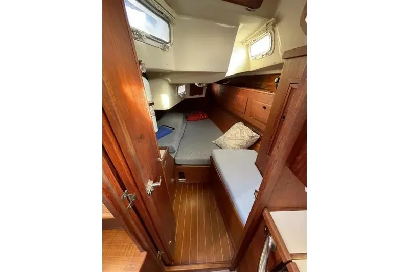 Slide: The Image of Cozy cabin interior of a 1990 Sabre 38 sailboat with wooden finishes and bedding. - 15