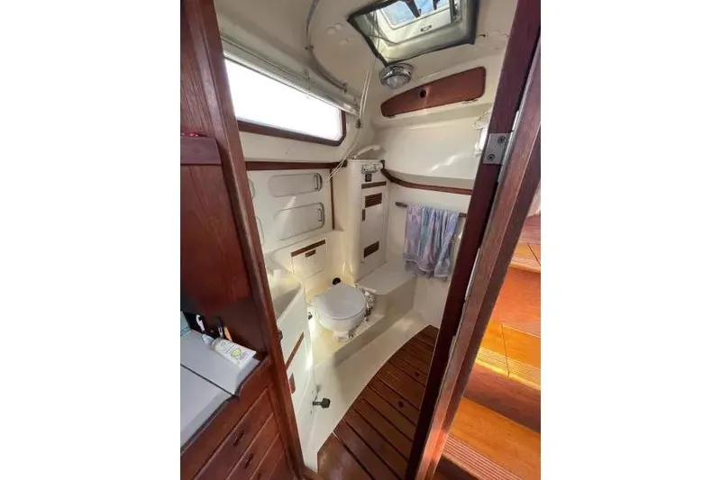 Slide: The Image of Interior of 1990 Sabre 38 sailboat bathroom with wooden accents and skylight. - 17
