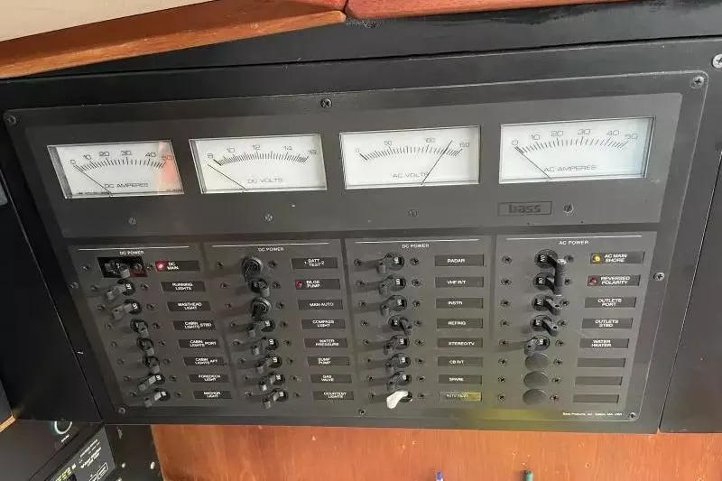 Slide: The Image of Electrical control panel on a 1990 Sabre 38 boat, featuring gauges and switches. - 18