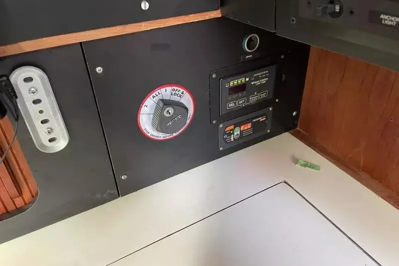 Slide: The Image of Control panel of a 1990 Sabre 38 yacht with switches and dials. - 19