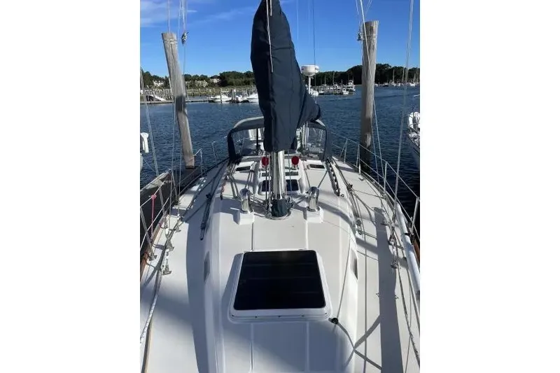Slide: The Image of Sailboat deck view of 1990 Sabre 38, docked in a marina under clear blue skies. - 2