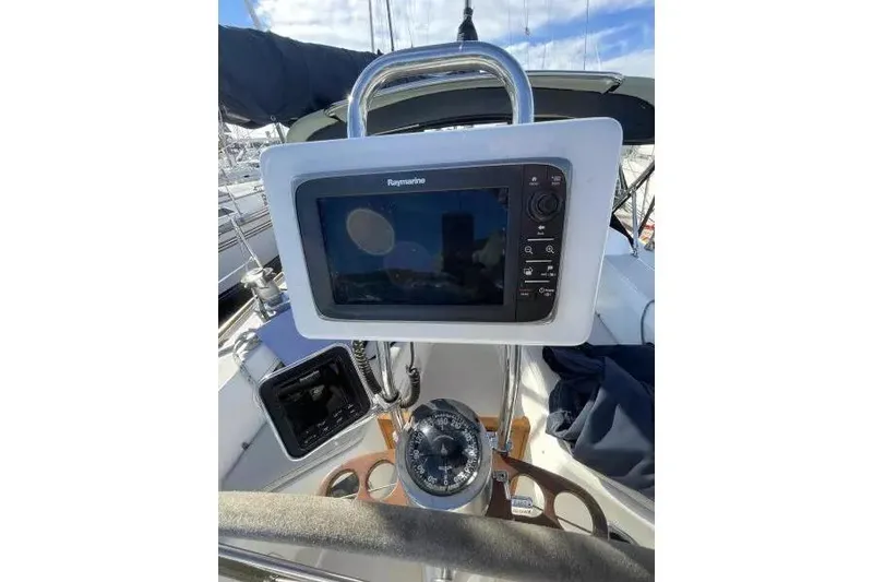 Slide: The Image of Cockpit of 1990 Sabre 38 sailboat featuring Raymarine navigation system and compass. - 6