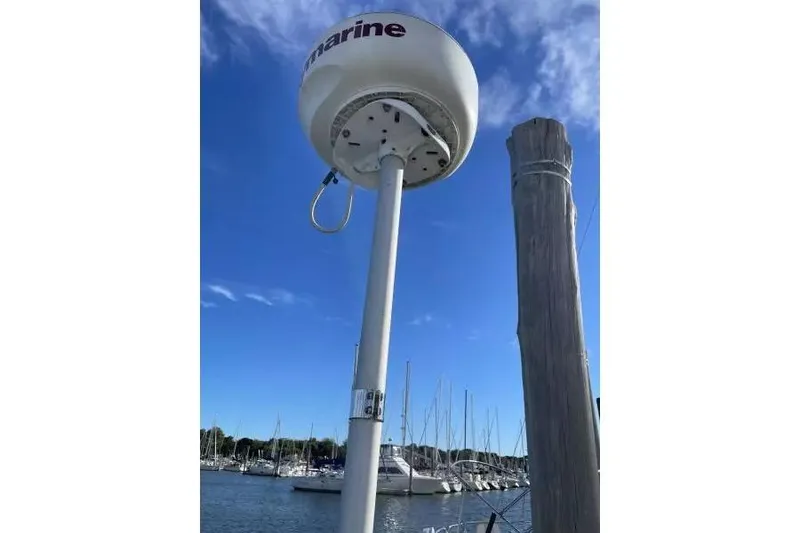 Slide: The Image of Marine radar on a dock with sailboats in the background, clear blue sky. Sabre 38, 1990. - 7