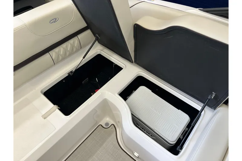 Slide: The Image of 2024 Regal LS2 boat interior storage compartments with cooler, showcasing luxury design. - 10