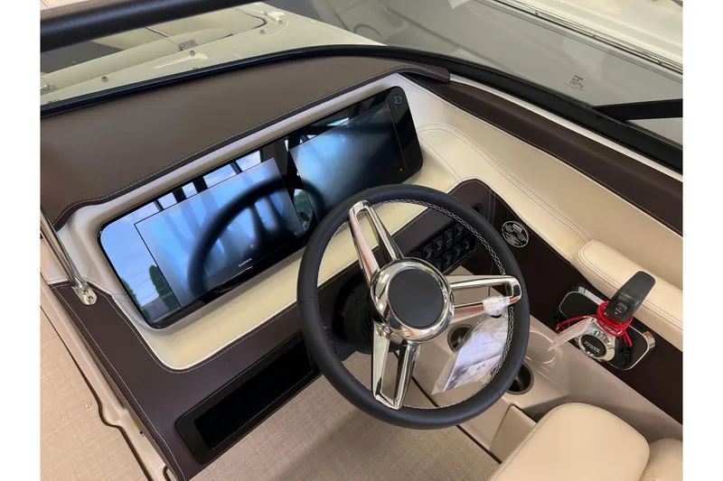 Slide: The Image of 2024 Regal LS2 boat dashboard with modern steering wheel and touchscreen display. - 13