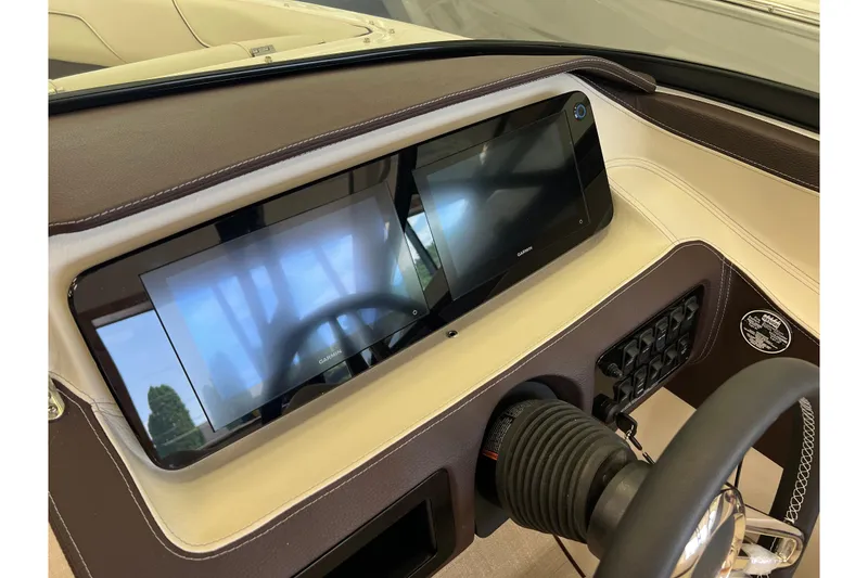 Slide: The Image of 2024 Regal LS2 boat dashboard with dual Garmin displays and steering wheel. - 14