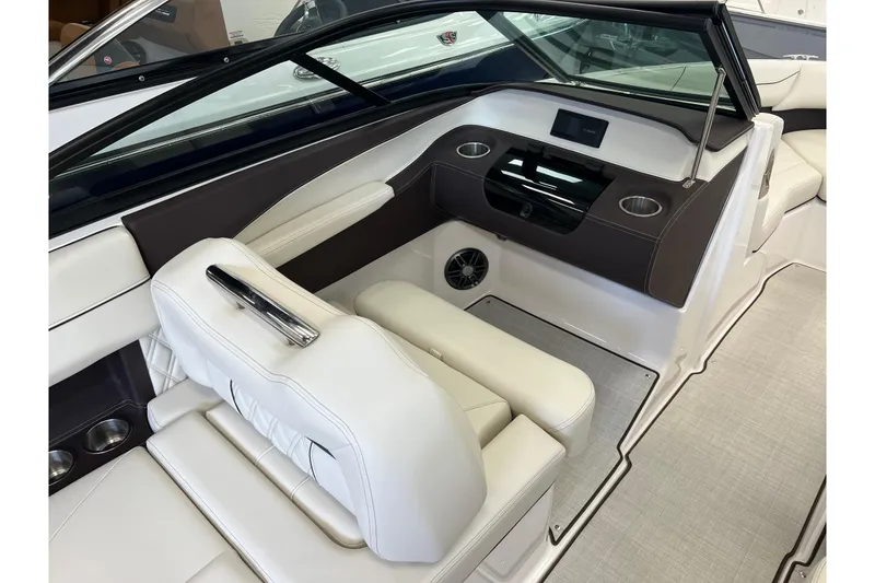 Slide: The Image of 2024 Regal LS2 boat interior with white seating, cup holders, and modern dashboard design. - 15