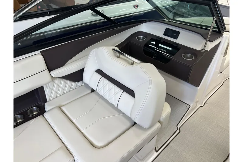 Slide: The Image of 2024 Regal LS2 boat interior with white leather seating and modern dashboard design. - 16