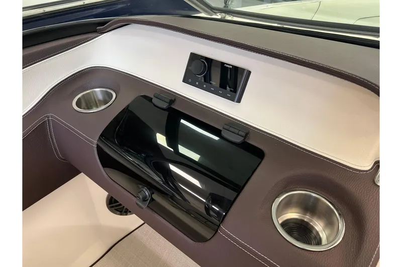 Slide: The Image of 2024 Regal LS2 boat dashboard with cup holders and control panel. - 17