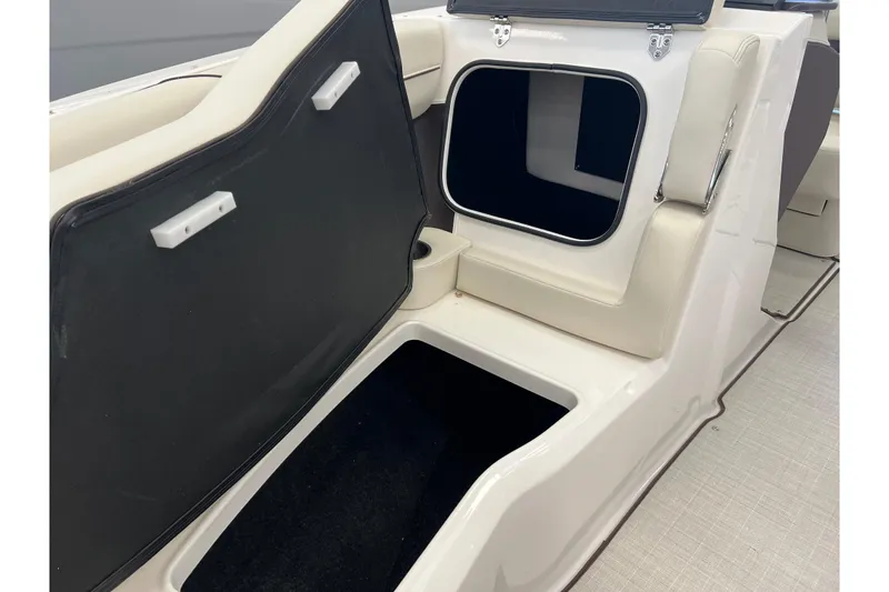 Slide: The Image of 2024 Regal LS2 boat interior storage compartments with open hatches, showcasing spacious design. - 21