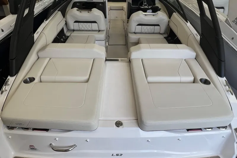 Slide: The Image of 2024 Regal LS2 boat interior with luxurious white seating and cup holders. - 4