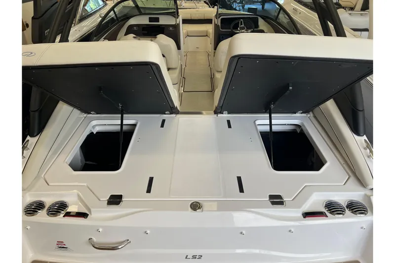 Slide: The Image of 2024 Regal LS2 boat interior with open storage compartments and sleek white seating. - 5