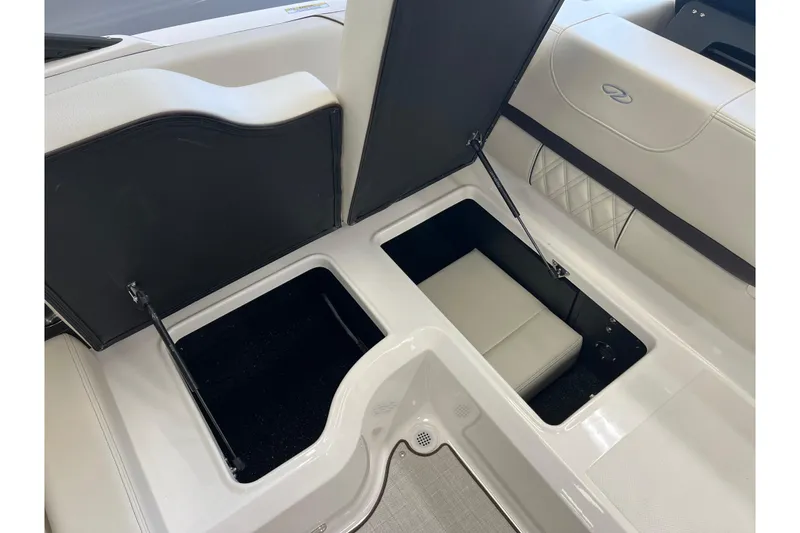 Slide: The Image of 2024 Regal LS2 boat interior storage compartments open, showcasing spacious design. - 9