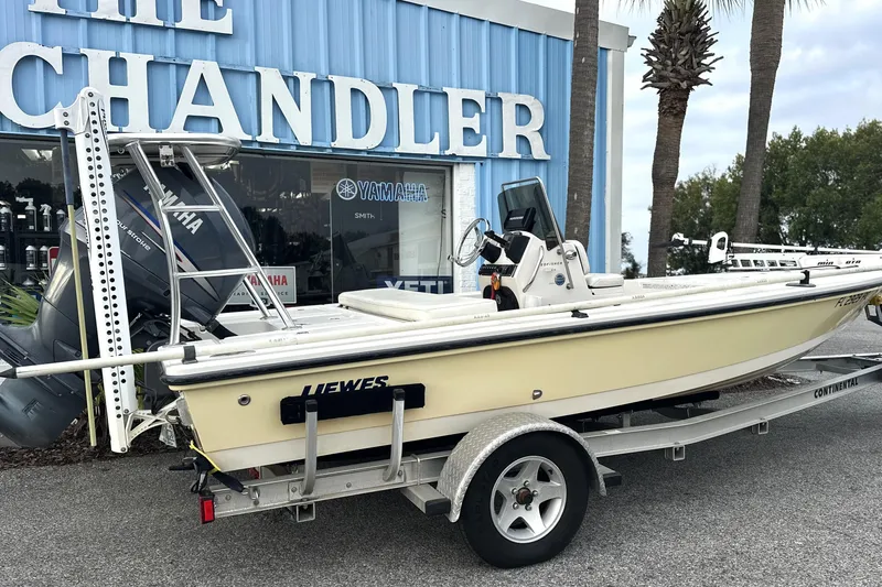 Slide: The Image of 2008 Hewes Redfisher 18 boat on trailer outside a marine store. - 1