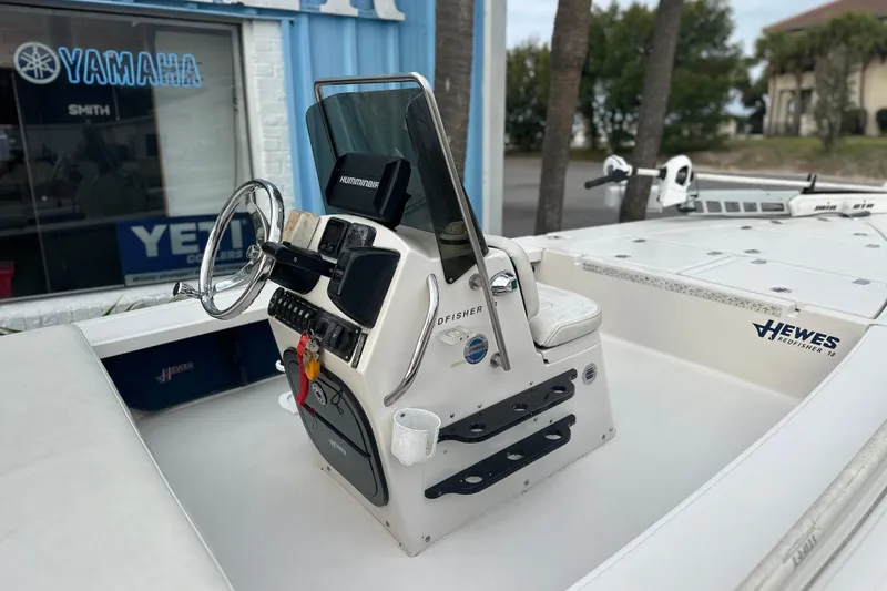 Slide: The Image of 2008 Hewes Redfisher 18 boat interior with steering console and branded decals. - 11