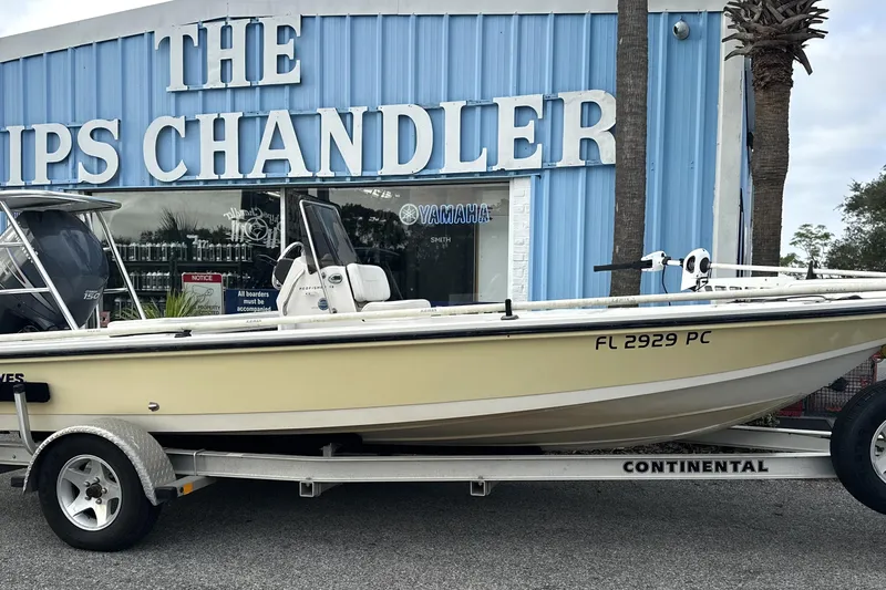 Slide: The Image of 2008 Hewes Redfisher 18 boat on trailer outside marine store. - 12