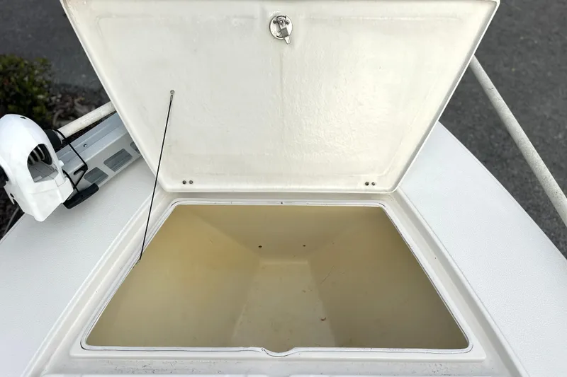 Slide: The Image of Open storage compartment on a 2008 Hewes Redfisher 18 boat, showcasing interior space. - 3