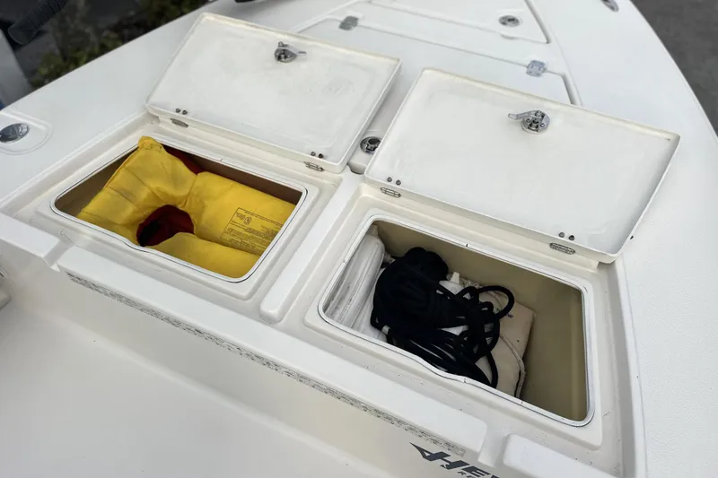 Slide: The Image of 2008 Hewes Redfisher 18 boat storage compartments with life jacket and ropes. - 4
