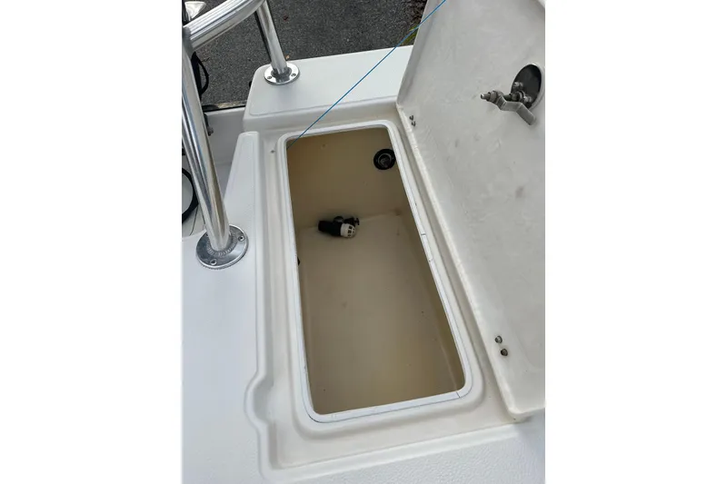 Slide: The Image of Open storage compartment on a 2008 Hewes Redfisher 18 boat. - 7