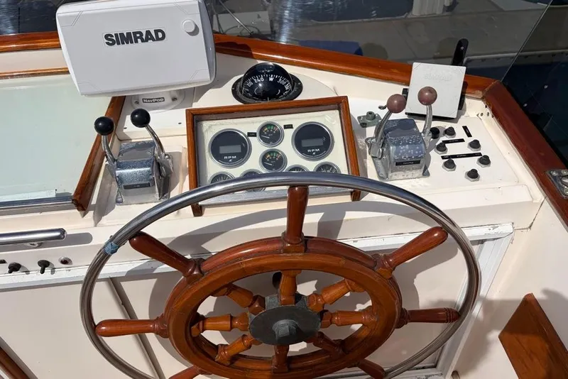 Slide: The Image of 1979 Grand Banks 42 Europa helm with wooden wheel and Simrad navigation system. - 10