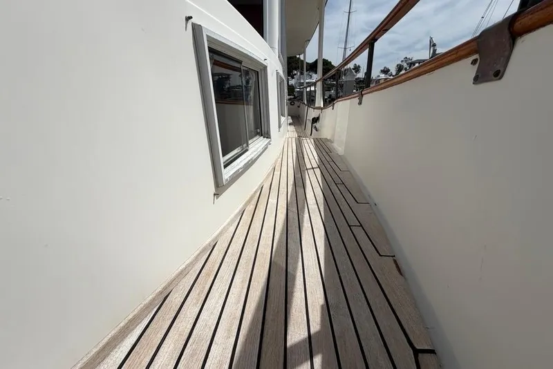 Slide: The Image of Side deck of a 1979 Grand Banks 42 Europa yacht with wooden flooring. - 18
