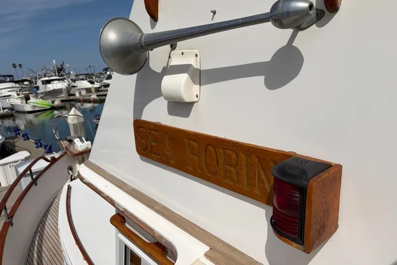 Slide: The Image of 1979 Grand Banks 42 Europa yacht "Sea Robin" docked at marina, showcasing nameplate and horn. - 21
