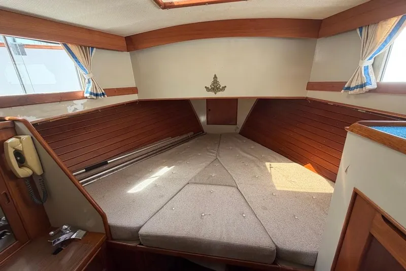 Slide: The Image of 1979 Grand Banks 42 Europa cabin interior with wood paneling and bed. - 23