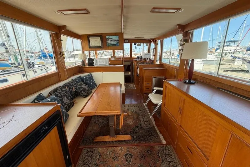 Slide: The Image of Interior of a 1979 Grand Banks 42 Europa yacht with wooden furnishings and marina view. - 24