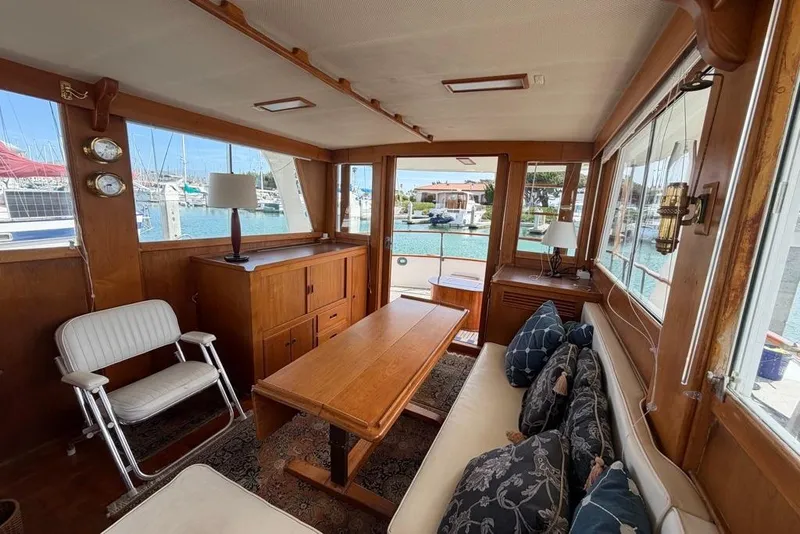 Slide: The Image of Interior of 1979 Grand Banks 42 Europa yacht with wooden furnishings and marina view. - 26