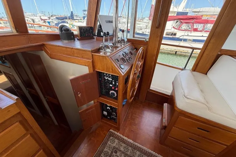 Slide: The Image of 1979 Grand Banks 42 Europa helm with wooden steering wheel and navigation instruments. - 28