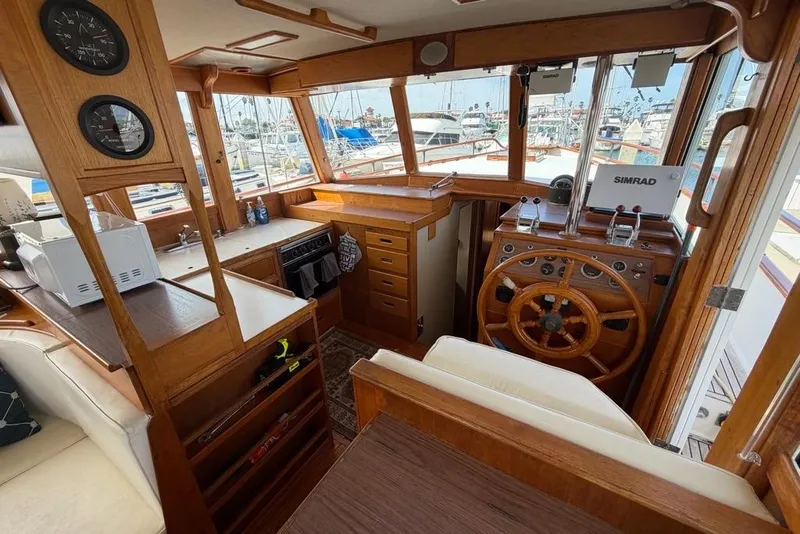 Slide: The Image of Interior of a 1979 Grand Banks 42 Europa yacht with wooden helm and nautical instruments. - 30