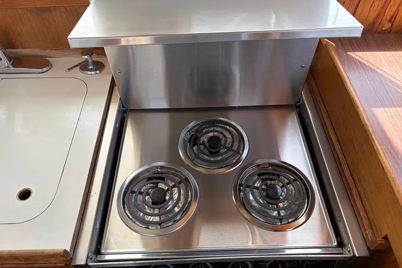 Slide: The Image of Stainless steel stove with three burners on a 1979 Grand Banks 42 Europa yacht. - 35