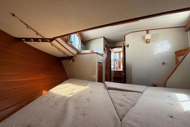 Slide: The Image of Interior cabin of 1979 Grand Banks 42 Europa yacht with wooden accents and cozy bedding. - 38