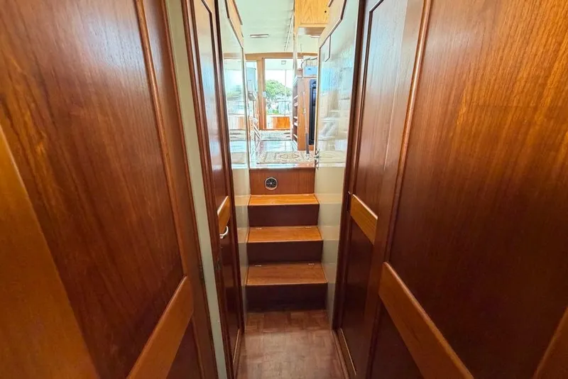 Slide: The Image of Interior hallway of 1979 Grand Banks 42 Europa yacht with wooden paneling and stairs. - 46