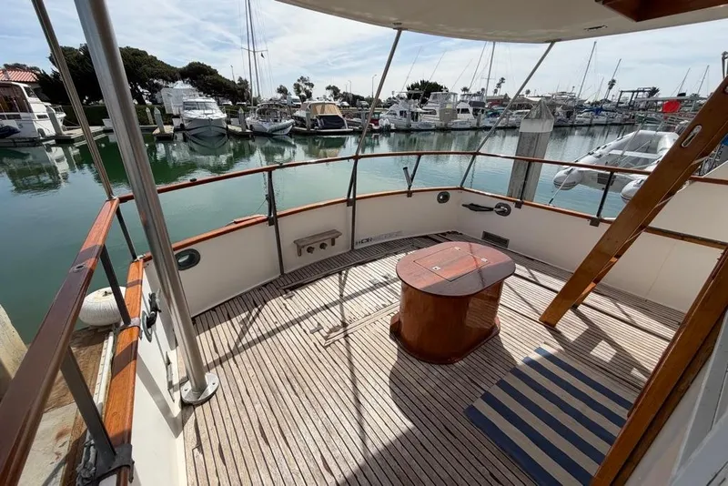 Slide: The Image of 1979 Grand Banks 42 Europa yacht deck with wooden flooring, docked at marina. - 5