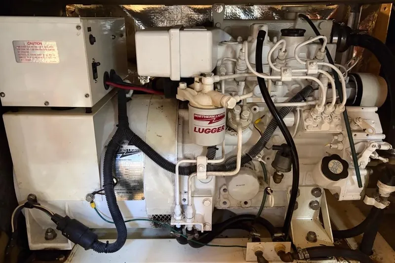 Slide: The Image of Engine compartment of a 1979 Grand Banks 42 Europa, featuring a Lugger marine engine. - 62