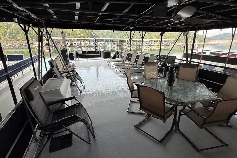 Slide: The Image of Spacious deck of 1998 Sumerset 16x76 houseboat with seating and scenic marina view. - 16