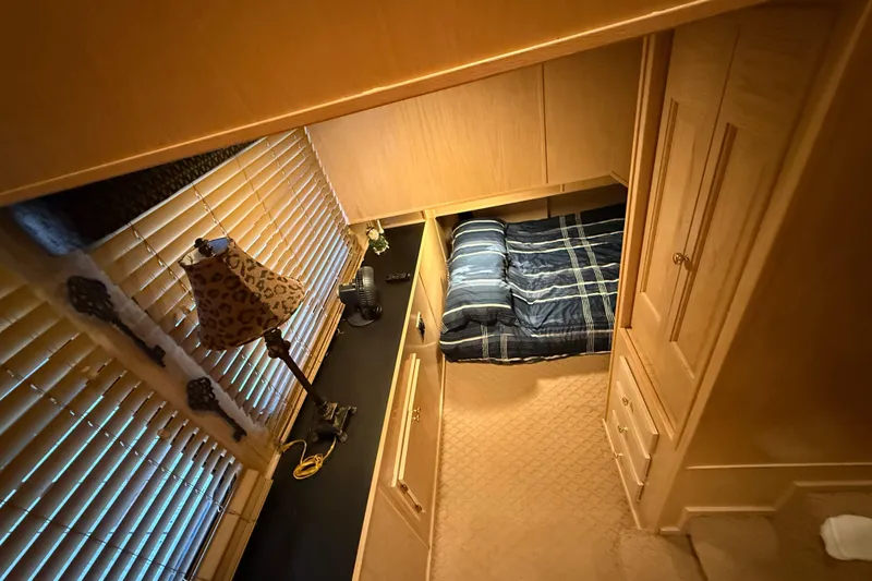 Slide: The Image of Cozy bedroom in 1998 Sumerset 16x76 houseboat with plaid bedding and wooden furnishings. - 8