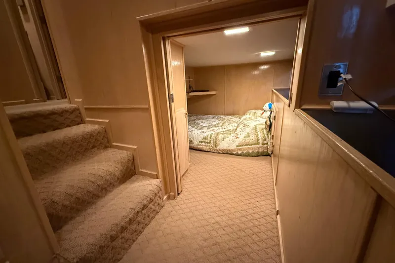 Slide: The Image of Cozy cabin interior with carpeted stairs and a small sleeping area in a 1998 Sumerset 16x76. - 9